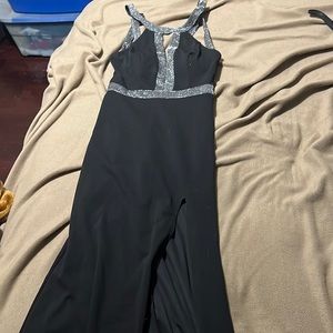 Long black dress with almost open back and a slit in the left leg.